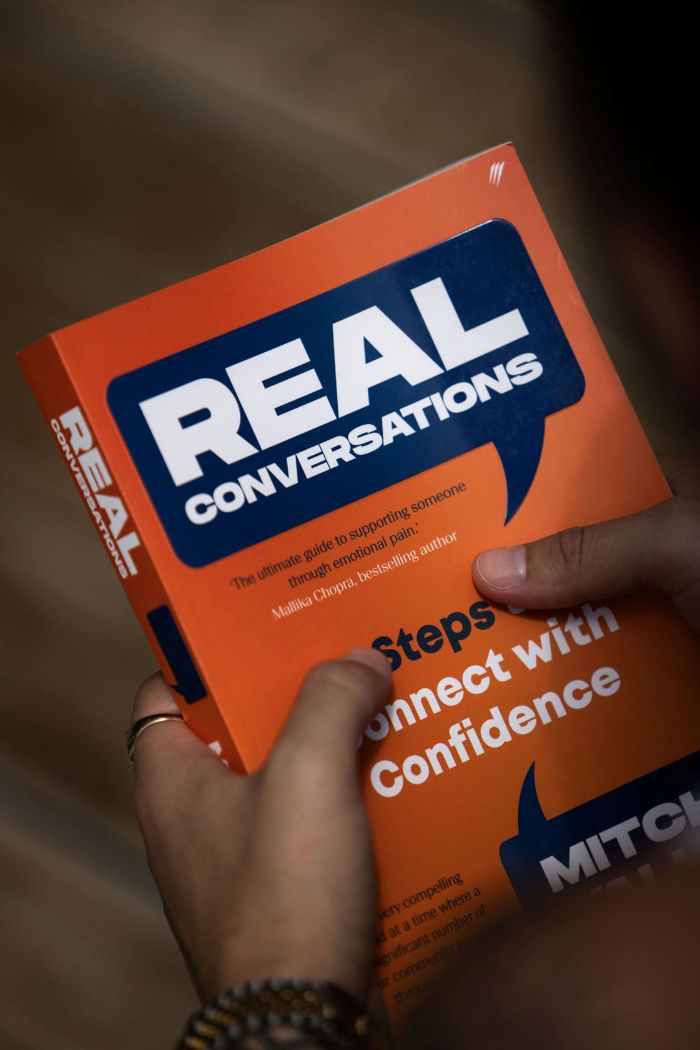 Real Conversations book held in hand